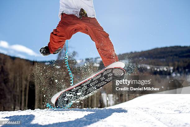 close up of a snow skate flipping on a sunny day. - snowboard jump close up stock pictures, royalty-free photos & images