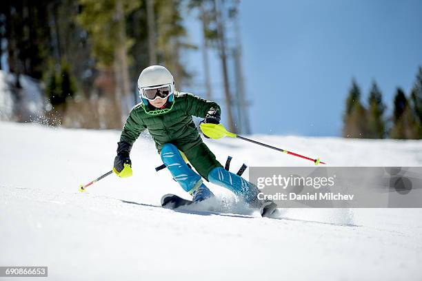 young kid racing skis on a sunny day. - esqui e snowboard imagens e fotografias de stock