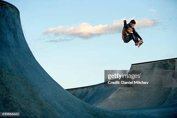 skateboarder jumping at a skate park. - jump stock-fotos und bilder