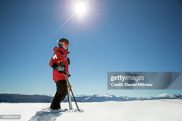 strong female ski patrol on top of a mountain. - vail colorado stock pictures, royalty-free photos & images