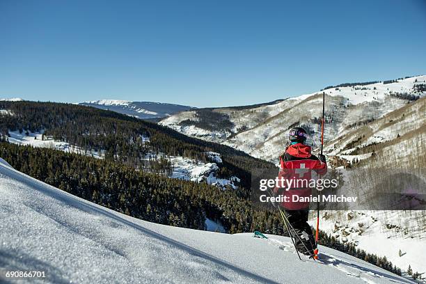 female ski patrol on skis checking the mountain. - ski patrol stock-fotos und bilder