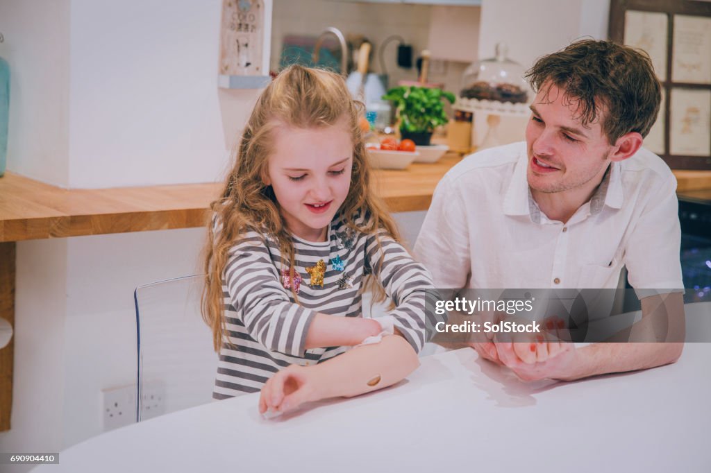 Father Helping his Daughter Paint her Prosthetic Limb Nails