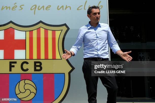 Barcelona's new coach Ernesto Valverde gestures as he poses outside the Camp Nou stadium in Barcelona on May 31, 2017 prior to signing his new...