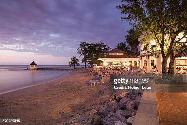 beach and cedar bar at half moon resort at dusk - montego bay stock pictures, royalty-free photos & images