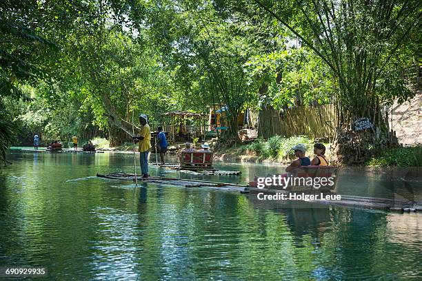 bamboo raft excursion on martha brae river - montego bay stock pictures, royalty-free photos & images