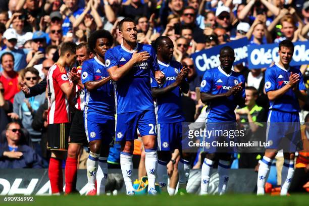 John Terry of Chelsea applauds the supporters as he leaves the field after being substituted during the Premier League match between Chelsea and...