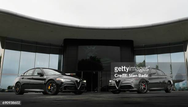Two Alfa Romeo Giulia vehicles are displayed before the Presidents Cup announcement of Alfa Romeo as the 3rd Global Partner at Liberty National Golf...