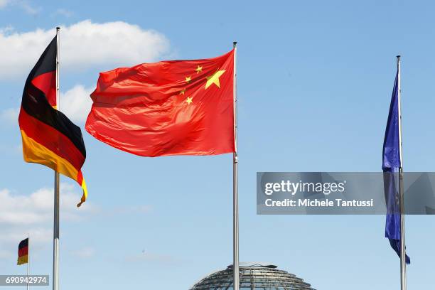 The Chinese Flag waves with the germans one ahead of the visit Chinese Prime Minister Li Keqiang at the Chancellery on May 31, 2017 in Berlin,...