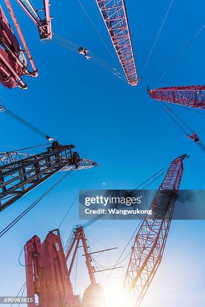 tower cranes - construction crane asia stock pictures, royalty-free photos & images