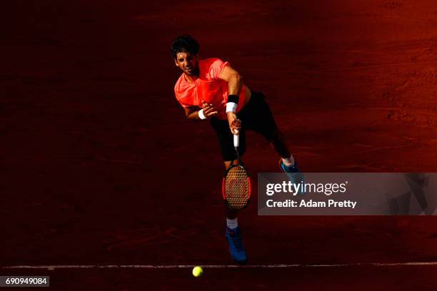 Thomaz Bellucci of Brazil serves during the mens singles second round match against Lucas Pouille of France on day four of the 2017 French Open at...