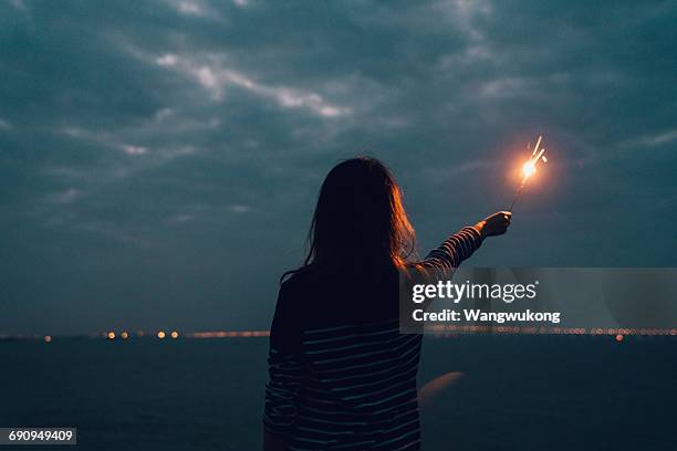 a girl with fireworks - sparkler stock pictures, royalty-free photos & images