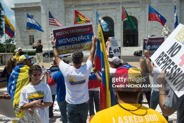 Supporters of the Venezuelan opposition demonstrate in front of the Organization of American States headquarters in Washington, DC, on May 31, 2017...