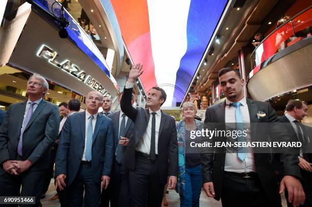 French President Emmanuel Macron waves to people during the delivery ceremony of the MSC Meraviglia cruise ship on May 31, 2017 at the STX shipyard...