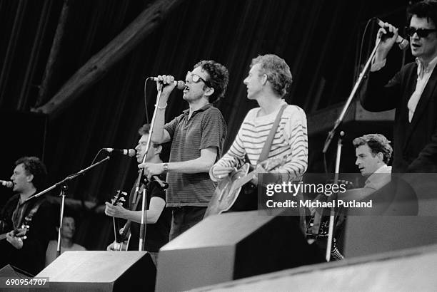 Folk-punk group The Pogues performing at the Glastonbury Festival near Pilton, Somerset, 20th June 1986. Left to right: Terry Woods, Jem Finer, Shane...