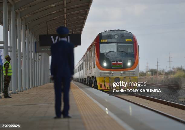 One of Kenya's newly acquired standard gauge rail locomotive, carrying Kenyan President pulls into Voi railway station on May 31, 2017 in Voi, during...