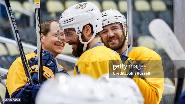 Mike Fisher has a laugh with PA Parenteau and assistant coach Phil Housley of the Nashville Predators as they wait for the zambomi to leave the ice...