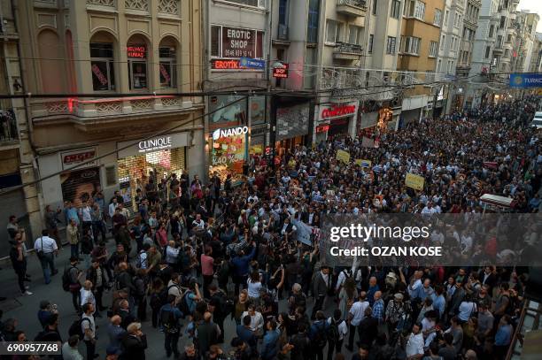 Demonstrators display banners as they march past on May 31, 2017 in Istanbul, on the fourth anniversary of the start of the Gezi Park protests. The...