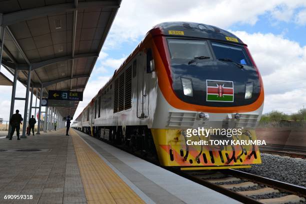 One of Kenya's newly acquired standard gauge rail locomotive, carrying Kenyan President pulls into Voi railway station on May 31, 2017 in Voi, during...