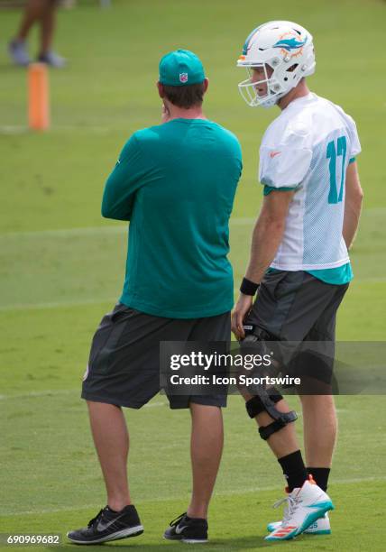 Miami Dolphins Quarterback Ryan Tannehill talks with Miami Dolphins Head Coach Adam Gase during a practice session at the Miami Dolphins training...