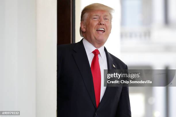 President Donald Trump shouts answers to reporters after Vietnamese Prime Minister Nguyen Xuan Phuc left the White House following meetings May 31,...