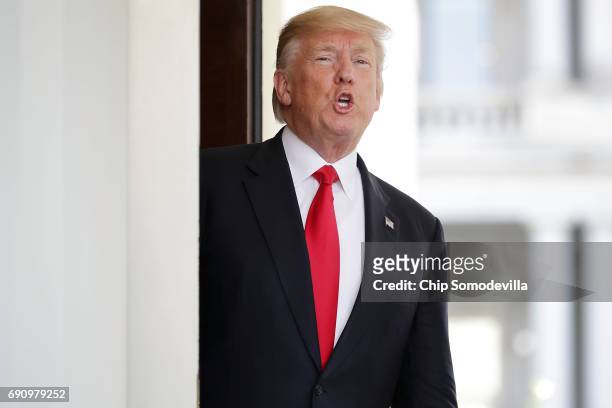 President Donald Trump shouts answers to reporters after Vietnamese Prime Minister Nguyen Xuan Phuc left the White House following meetings May 31,...
