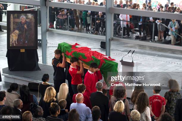 Rhodri Morgan's grandchildren carry his coffin from the stage during the funeral of the former First Minister of Wales Rhodri Morgan at the Senedd in...