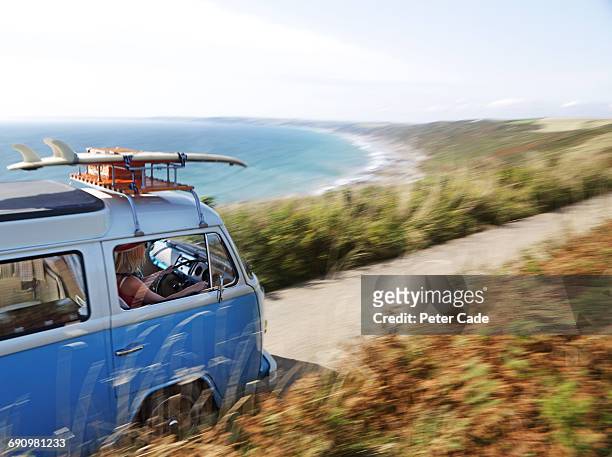 woman driving camper van along coastal road - european landscapes stock pictures, royalty-free photos & images