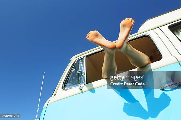 woman's feet out of window of camper - feet up stock pictures, royalty-free photos & images