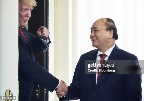 President Donald Trump, left, shakes hands with Nguyen Xuan Phuc, Vietnam's prime minister, after a meeting at the West Wing of the White House in...