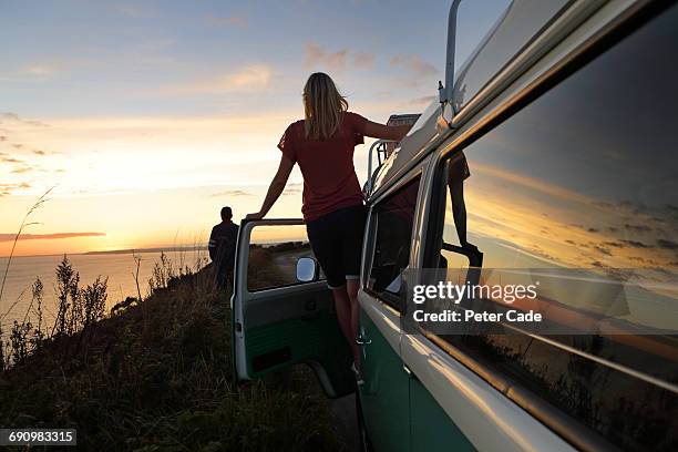 woman stood on camper looking at view, man ahead - car rear view stock pictures, royalty-free photos & images