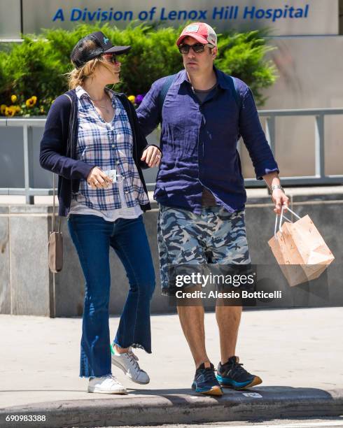 Jason Biggs and wife Jenny Mollen are seen walking in West Village after having breakfast at Sant Ambroeus on May 31, 2017 in New York City.