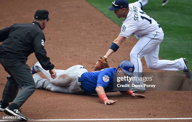 Willson Contreras of the Chicago Cubs is tagged out by Ryan Schimpf of the San Diego Padres as he tries to steal third base during the second inning...