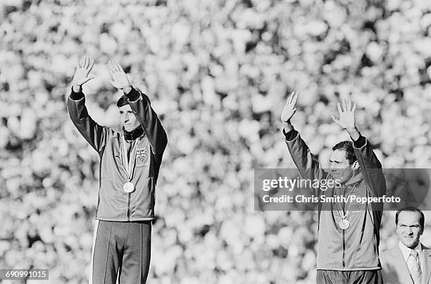 Gold medallist track athlete Sebastian Coe and bronze medallist Steve Ovett, both of the Great Britain team pictured together waving to the crowd...