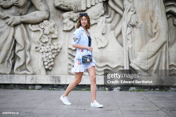 Bianca Derhy, fashion blogger Bibi Goes Chic, wears a Shein skirt with embroidered flowers, a Rails top with lace, Converse white sneakers shoes, and...