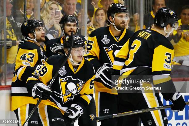 Jake Guentzel of the Pittsburgh Penguins celebrates with teammates after scoring a goal during the first period in Game Two of the 2017 NHL Stanley...