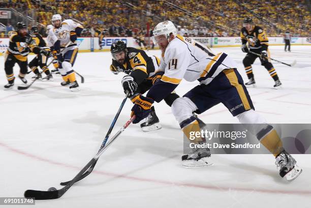 Mattias Ekholm of the Nashville Predators and Justin Schultz of the Pittsburgh Penguins battle for the puck during the first period of Game Two of...