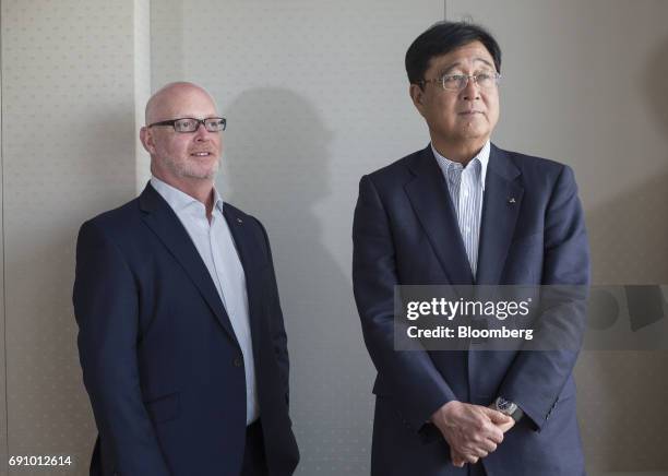 Trevor Mann, chief operation officer of Mitsubishi Motors Corp., left, and Osamu Masuko, president and chief executive officer, pose for a photograph...