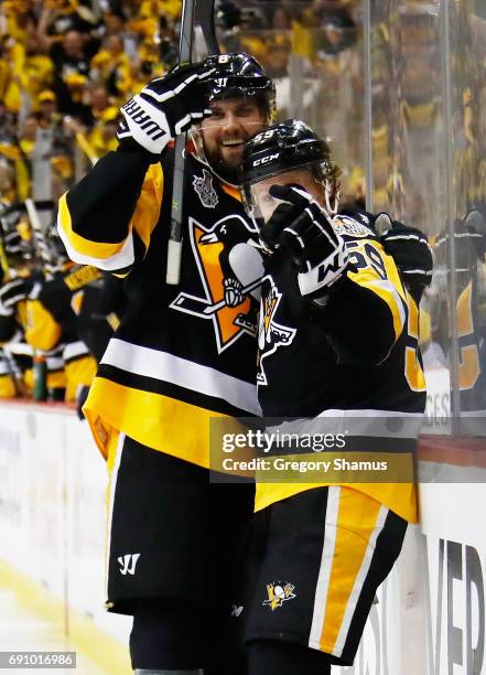 Jake Guentzel of the Pittsburgh Penguins celebrates with Brian Dumoulin after scoring a goal during the third period in Game Two of the 2017 NHL...