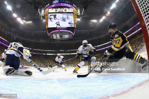 Sidney Crosby of the Pittsburgh Penguins and P.K. Subban of the Nashville Predators watch as goaltender Pekka Rinne makes a save during the first...