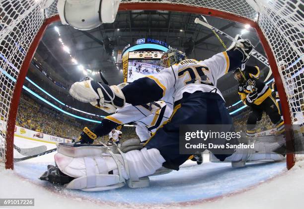 Goaltender Pekka Rinne of the Nashville Predators stretches for a save as Nick Bonino of the Pittsburgh Penguins looks on during the first period of...