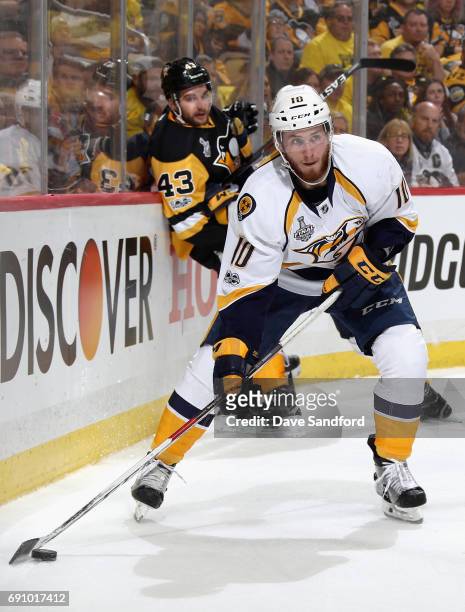 Colton Sissons of the Nashville Predators skates with the puck away from Conor Sheary of the Pittsburgh Penguins during the second period of Game Two...