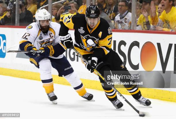 Evgeni Malkin of the Pittsburgh Penguins controls the pcuk away fromMike Fisher of the Nashville Predators during the third period of Game Two of the...