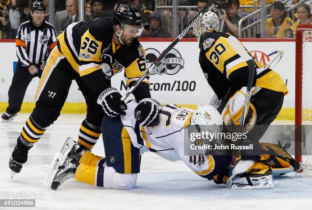 Pontus Aberg of the Nashville Predators is shoved into goaltender Matt Murray of the Pittsburgh Penguins by Ron Hainsey during the third period of...