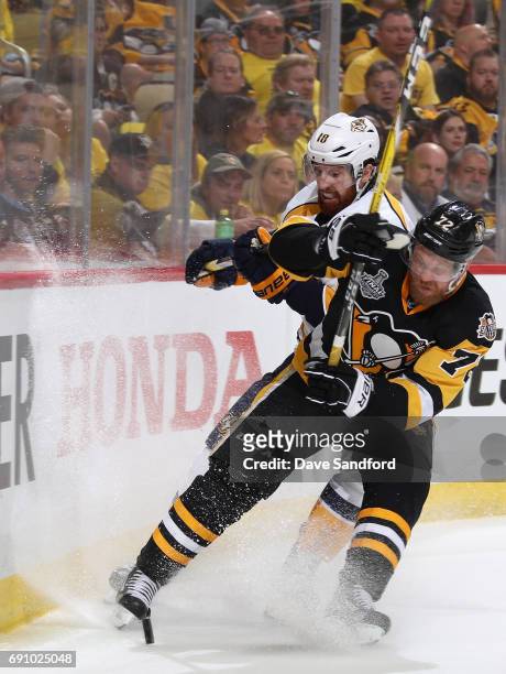 Patric Hornqvist of the Pittsburgh Penguins collides with James Neal of the Nashville Predators at the boards during the third period of Game Two of...