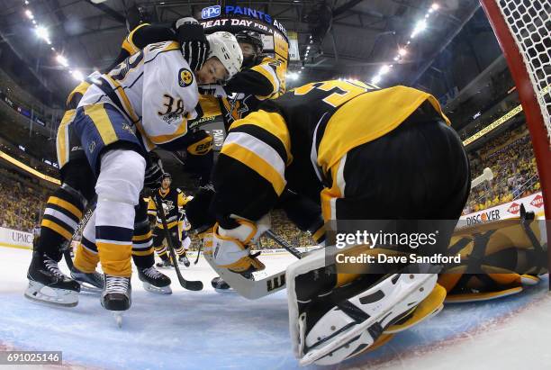 Viktor Arvidsson of the Nashville Predators is grabbed in front of goaltender Matt Murray of the Pittsburgh Penguins during the second period of Game...