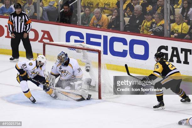 Pittsburgh Penguins center Scott Wilson shot deflects off Nashville Predators center Vernon Fiddler and into the net behind goalie Pekka Rinne during...