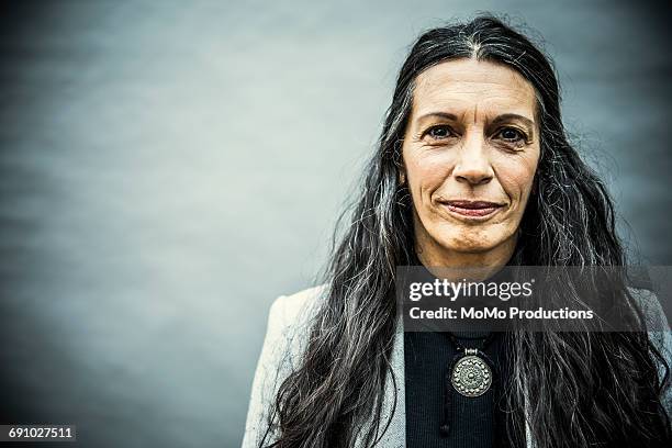 portrait of senior woman with long hair - grittywomantrend stock pictures, royalty-free photos & images