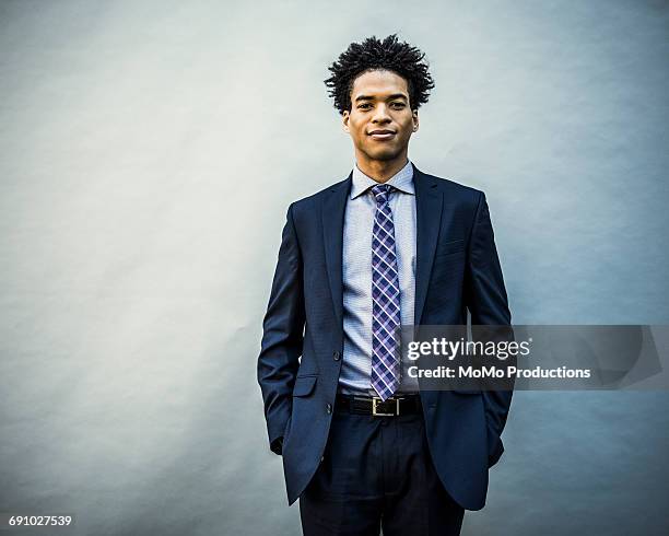 portrait of young businessman - black suit stock-fotos und bilder