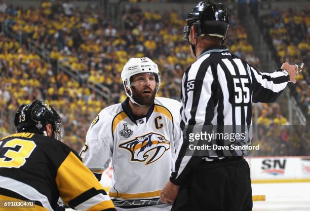 Linesman Shane Heyer throws Mike Fisher of the Nashville Predators out of the face off circle during the first period of Game Two of the 2017 NHL...