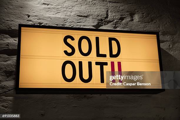 close-up of sold out signboard against gray wall - cinema sign stock pictures, royalty-free photos & images